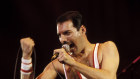 Freddie Mercury and Queen, performing live on stage.