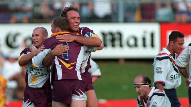 Broncos icons Allan Langer, Darren Lockyer and Gorden Tallis embrace after defeating Sydney City Roosters at then-ANZ Stadium in 1998. 