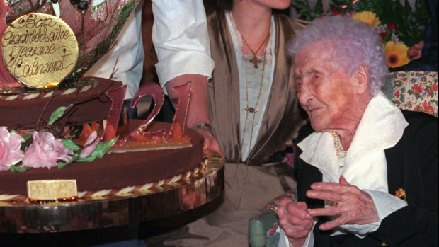 Jeanne Calment looks at her birthday cake as she celebrates her 121th birthday at her retirement home in Arles.