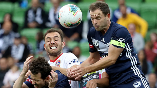 Nodding off: Victory's Leigh Broxham climbs over the pack as teammate Robbie Kruse takes cover.
