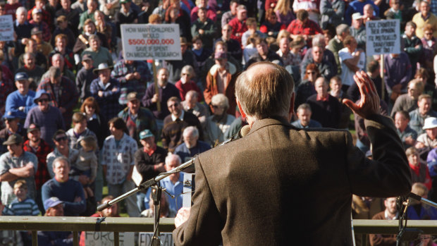 John Howard wears a bullet-proof vest at a rally in Sale in June 1996 to argue for gun restrictions. The national registry that was promised at the time has never eventuated.