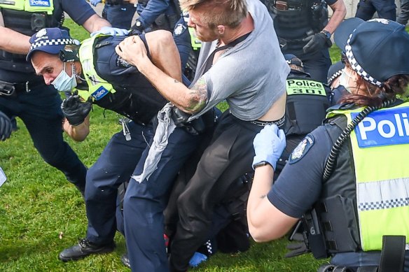 A police officer and protester in a scuffle in an anti-lockdown protest in September last year.