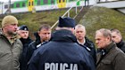 Prime Minister Donald Tusk, second right, visits the site of the rail line sabotage attack. 