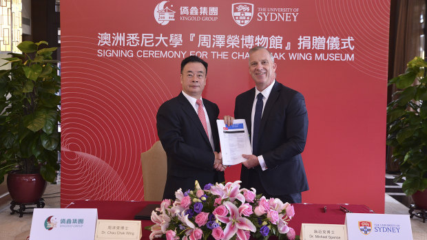 Chau Chak Wing and vice-chancellor of the University of Sydney Dr Michael Spence in Guangdong, China, shaking hands on the gift to build the Chau Chak Wing Museum.