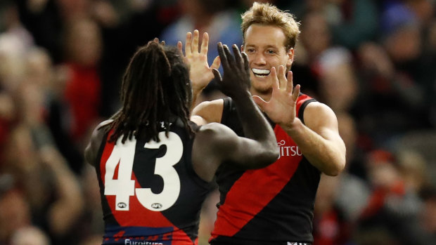 Anthony McDonald-Tipungwuti and Darcy Parish celebrate a goal during the Bombers’ clash with the Dockers  at Marvel Stadium.