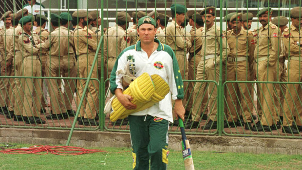 Watchful eye: Shane Warne of Australia steps on to the pitch as Pakistan police look on during Australia nets session prior to the 1996 World Cup Final between Australia and Sri Lanka played in Lahore, Pakistan.
