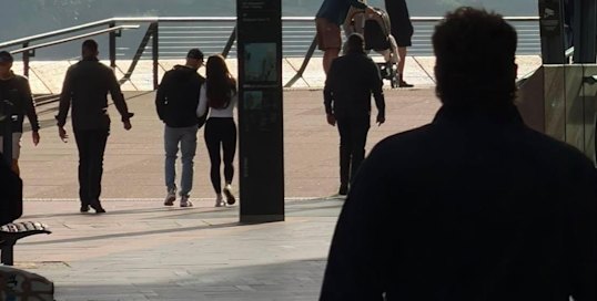 Jeff Bezos and wife Lauren Sanchez Bezos strolling near the Opera House surrounded by bodyguards.
