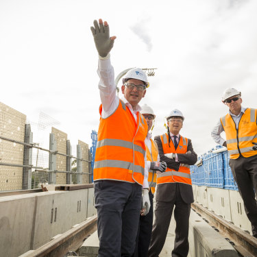 Andrews visits the partly constructed Noble Park "sky rail" overpass in 2018. Tackling the traffic bottlenecks created by rail-and-road intersections this way has been popular with the electorate.  