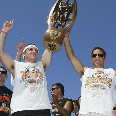 Robbie Farah and Benji Marshall celebrate the 2005 grand final triumph with teammates.
