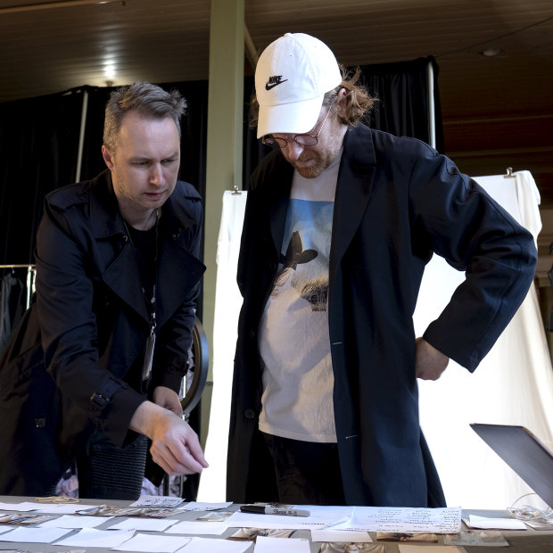 Toni Maticevski (left) and stylist Jolyon Mason look over the running order for the show.