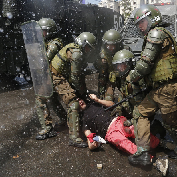 Police subdue a protester on October 20 in Santiago.