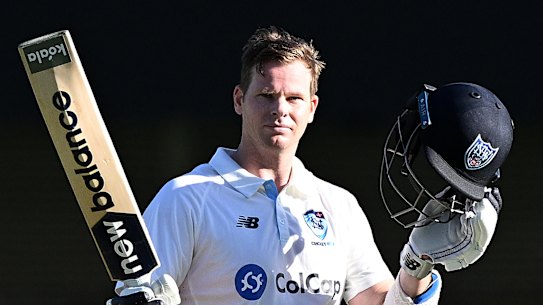 Steve Smith salutes for his century.