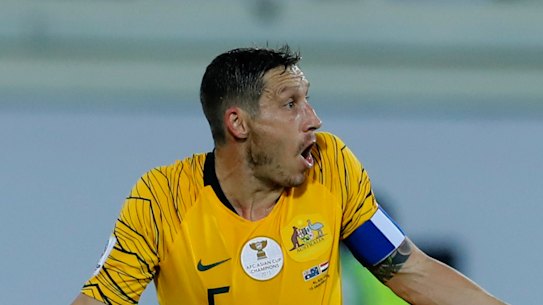 What's the deal?: Socceroos midfielder Mark Milligan says the pitch at the Khalifa bin Zayed Stadium was too hard.