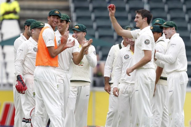 Pat Cummins (second from right) on debut in 2011 after bowling Morne Morkel. 