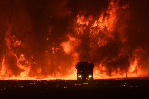 A fire crew is overwhelmed at Orangeville, south-west of Sydney, on December 5, 2019. The prime minister returned to Sydney later that month.