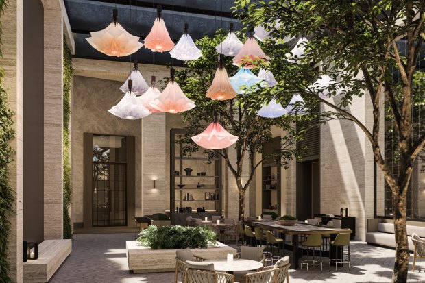 An art installation in the glass-enclosed atrium features remotely operated artificial flowers that open and close above diners’ heads.