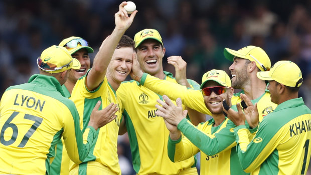 Australia's Jason Behrendorff, centre, celebrates after taking the wicket of England's Jofra Archer.
