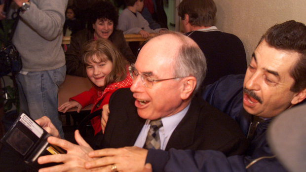 PM John Howard tries to pay for his first GST coffee at the Rendezvous Coffee House shop on July 1, 2000.