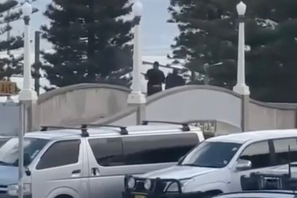 The alleged shooter on a pedestrian bridge behind Bondi Pavilion.