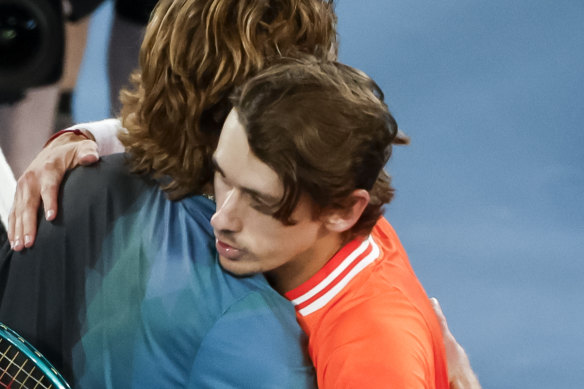 Rublev and de Minaur embrace at the net.