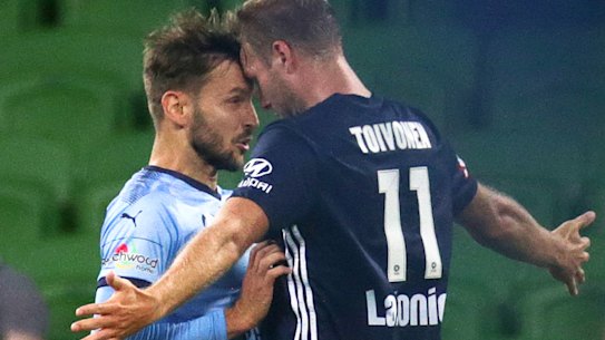 Plenty of feeling: Victory's Ola Toivonen and Milos Ninkovic of Sydney FC clash during the last Big Blue.
