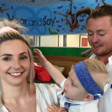 Rome Whelan, 18 months, is seen with his mother Renae Whelan and father Ryan Walker, celebrating his new cochlear implant.