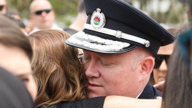RFS Commissioner Shane Fitzsimmons hugs Melissa O'Dwyer, the wife of NSW RFS volunteer Andrew O'Dwyer, during his funeral service. 