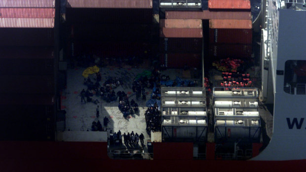 September 2001: Asylum seekers prepare to be transferred by special forces between the Norwegian freighter MV Tampa and HMAS Manoora off Christmas Island.