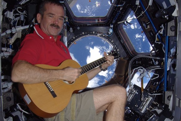 Hadfield on board the ISS with his guitar,
