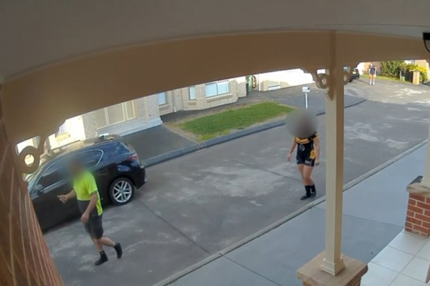 Two blurred figures standing on a footpath following an alleged 