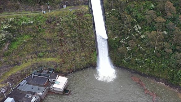 The Thomson Dam spills over in October 2022.
