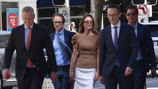 Bianca Rinehart and John Hancock arriving flanked by lawyers on Tuesday, the second day of closing submissions in the Hope Downs civil trial.