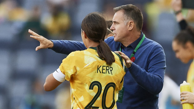 Coach Ante Milicic and Sam Kerr confer on the sidelines.