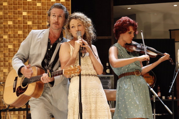 Tim Rogers on stage with Sophie Ross and fiddle player Xani Kolac in What Rhymes with Cars and Girls.