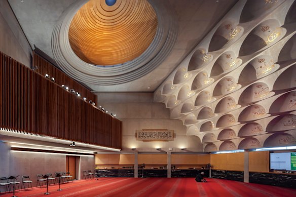 The mosque’s concrete-domed ceiling allows pinholes of natural light into the main hall.