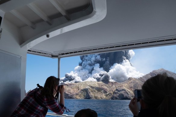 Smoke spews into the air after the volcano eruption on White Island.