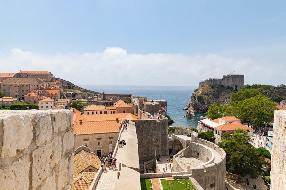 City wall and Pile Gate with Lovrijenac Fortress in background in Dubrovnik.