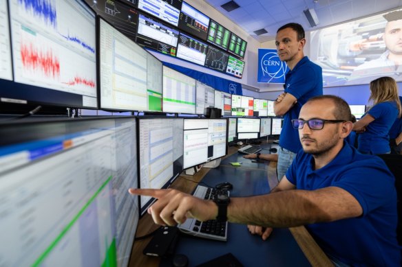 CERN scientists observe the resumption of collisions of the Large Hadron Collider from the control room.