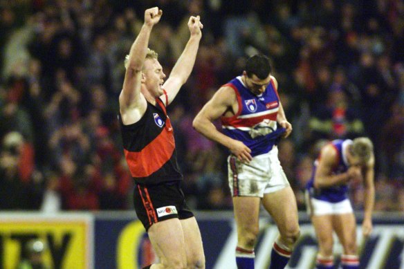 Essendon’s Paul Barnard jubilant and exhausted as the siren goes.