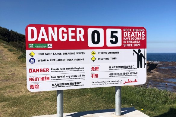 A new warning sign at Hill 60 where five men died rock fishing this year. Lifesaver Anthony Turner was involved in finding two men who died after being swept off the rocks.