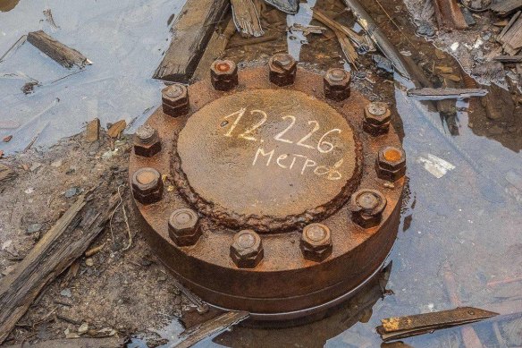 The small entrance to Russia’s borehole, the deepest hole in the world, is sealed off in the ruins of an abandoned Arctic research station.