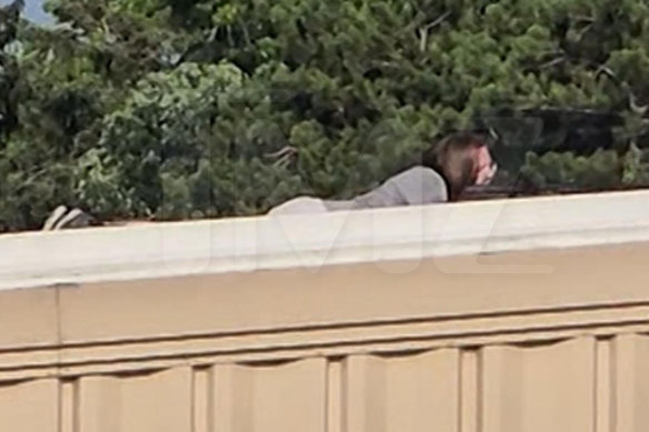 A screen grab from a video shot by a bystander and sourced by celebrity website TMZ shows the shooter – Thomas Matthew Crooks – on a rooftop.