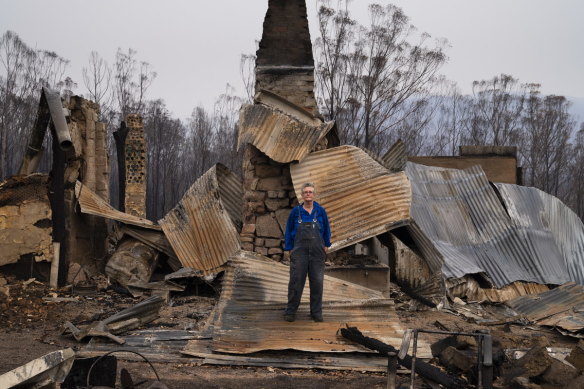 Gideon Mendel’s award-winning image of Jenni Bruce in front of her ruined home.