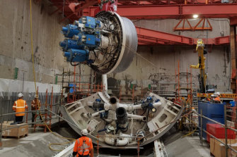  One of two huge tunnel boring machines is lowered into place for assembly in the Metro Tunnel underground works area in North Melbourne. Two tunnel boring machines will dig the entire 9-kilometre twin tunnels.