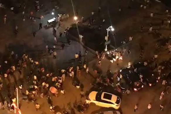 People gather at the square after a car ploughed into a large crowd in Mishui, China. 