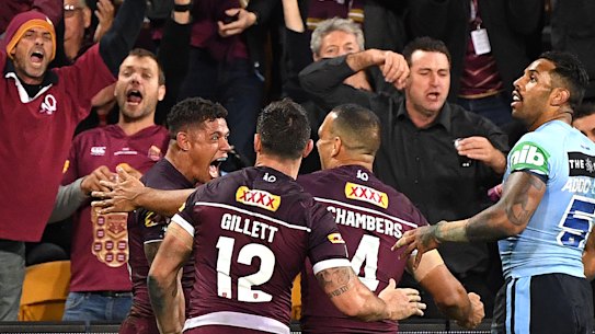 Game breaker: Queensland celebrate Dane Gagai's 95m intercept try that turned the game on its head.