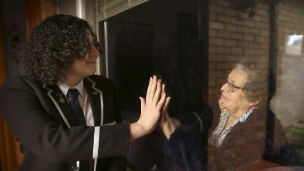 Reaching out during isolation: Sydney Boys High School student William Winter with his elderly grandmother at their Georges Hall family home.