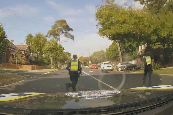 Police run to the scene of the crash.