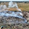 Waste material smoulders at the alleged unlawful burn-off site in Wollert.