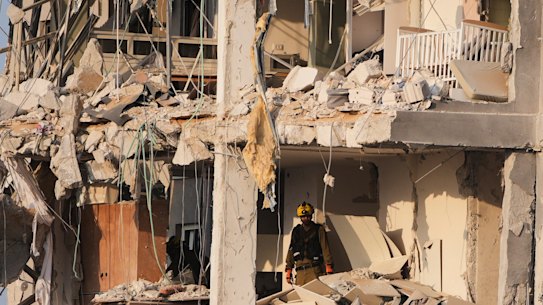 sraeli security forces inspect a destroyed building that was hit by a missile fired from Iran.